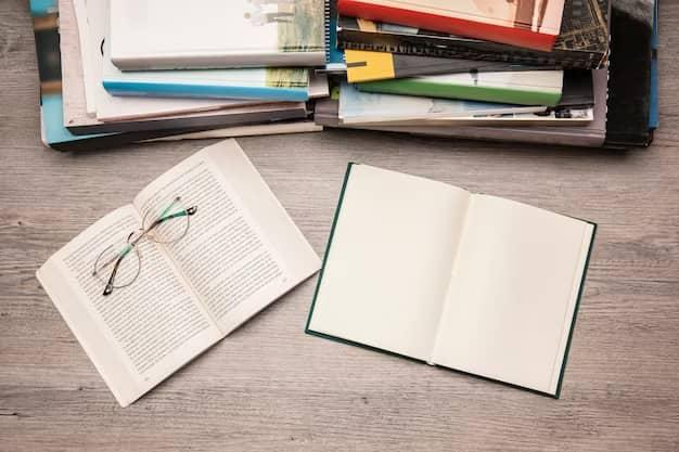 An open book lies on the table, with glasses on top of it